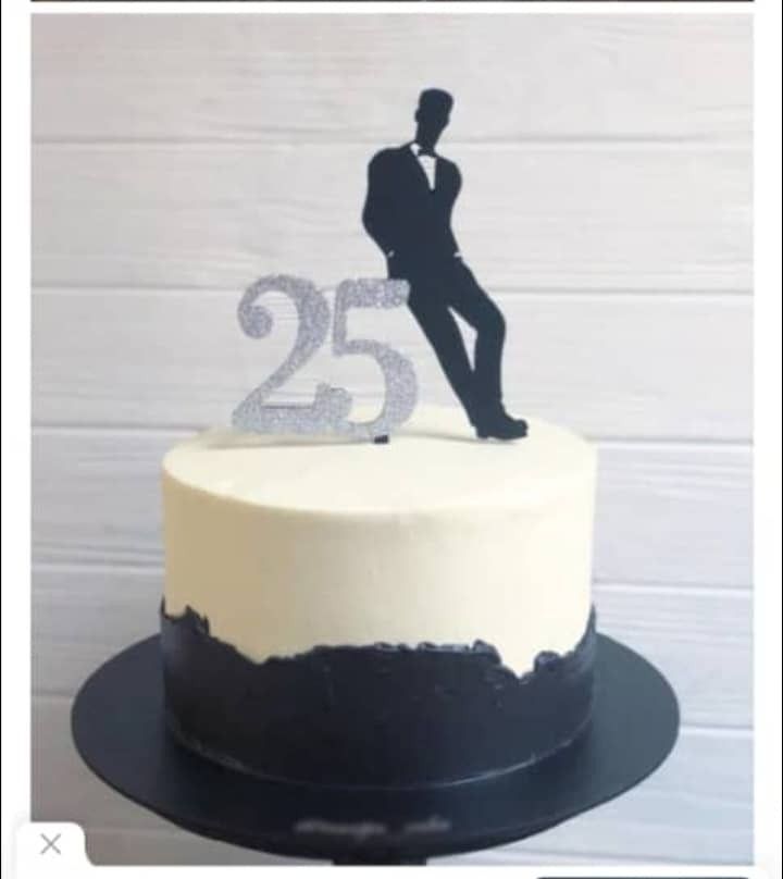 a white and black cake with a silhouette of a man on top