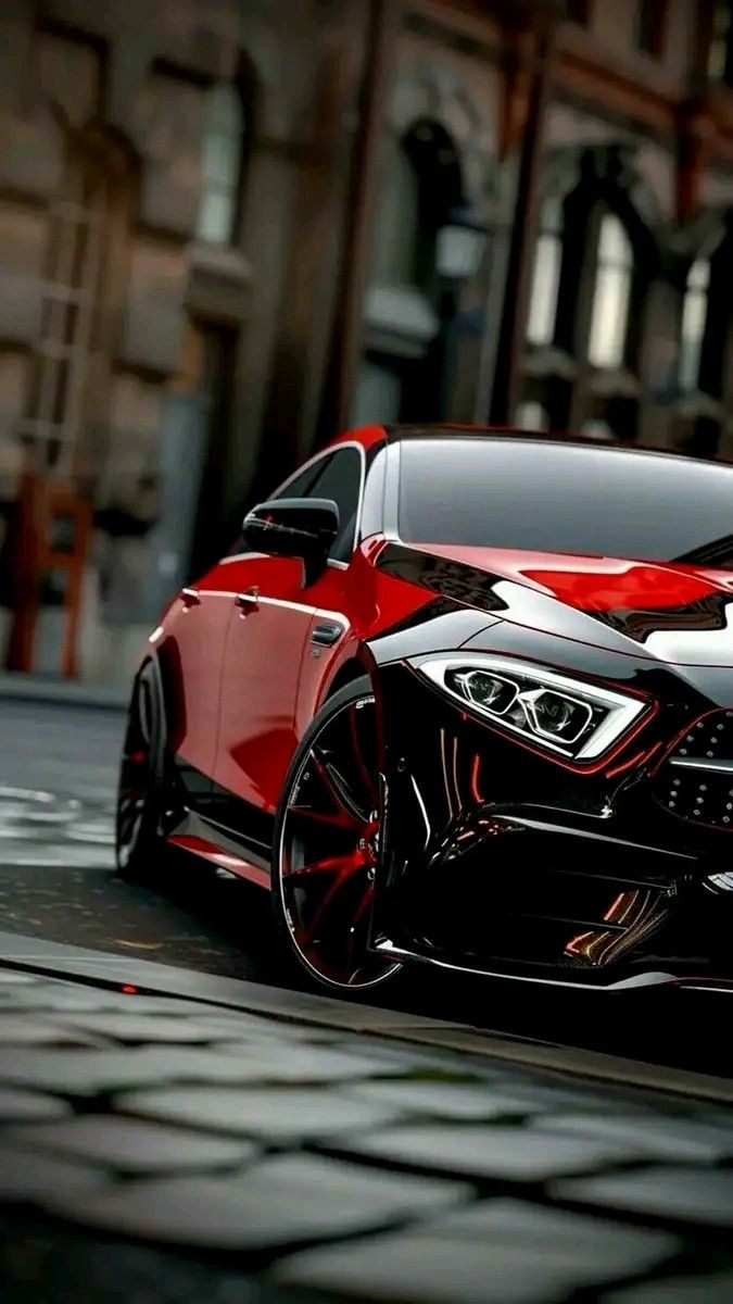 a red and black sports car parked in front of a building