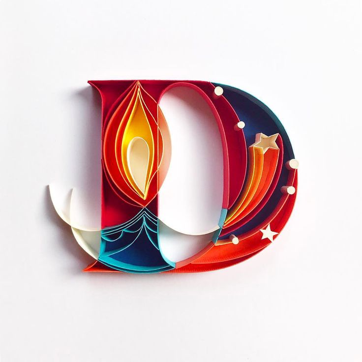 the letter d is made out of paper and cut into smaller shapes, including an ornament