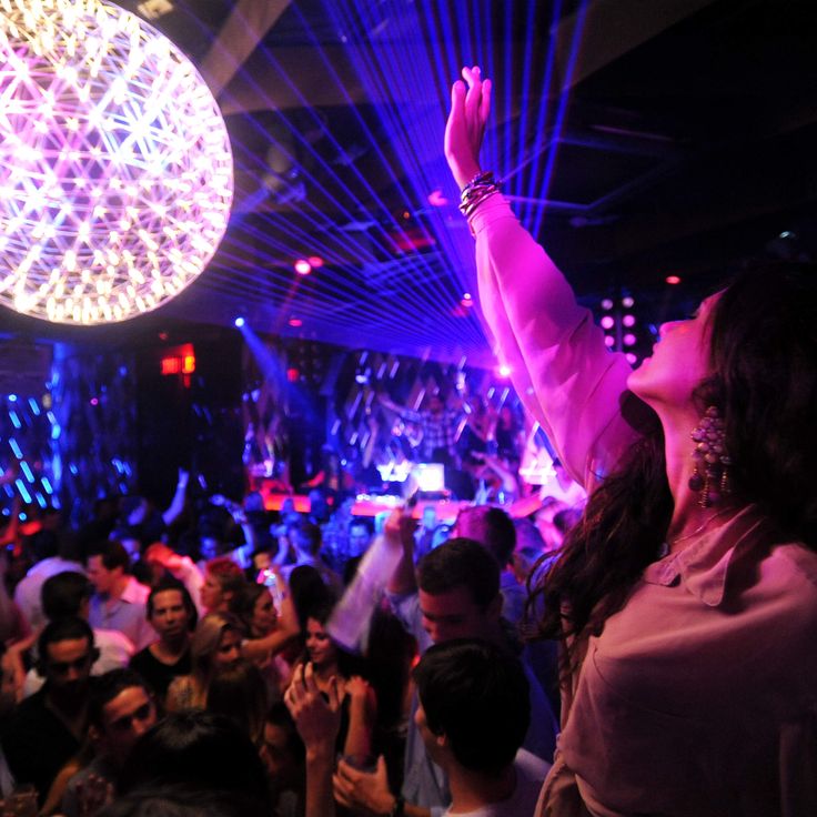 a woman standing in front of a crowd at a concert