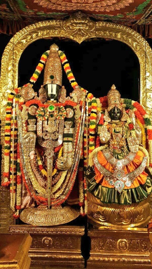 the statue is decorated with gold and red decorations