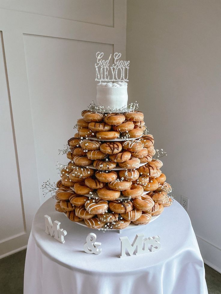 a wedding cake made out of donuts on top of a table