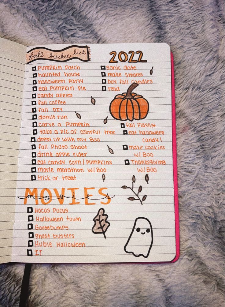 an open notebook with the words movies written in orange and black on it, sitting on a furry surface