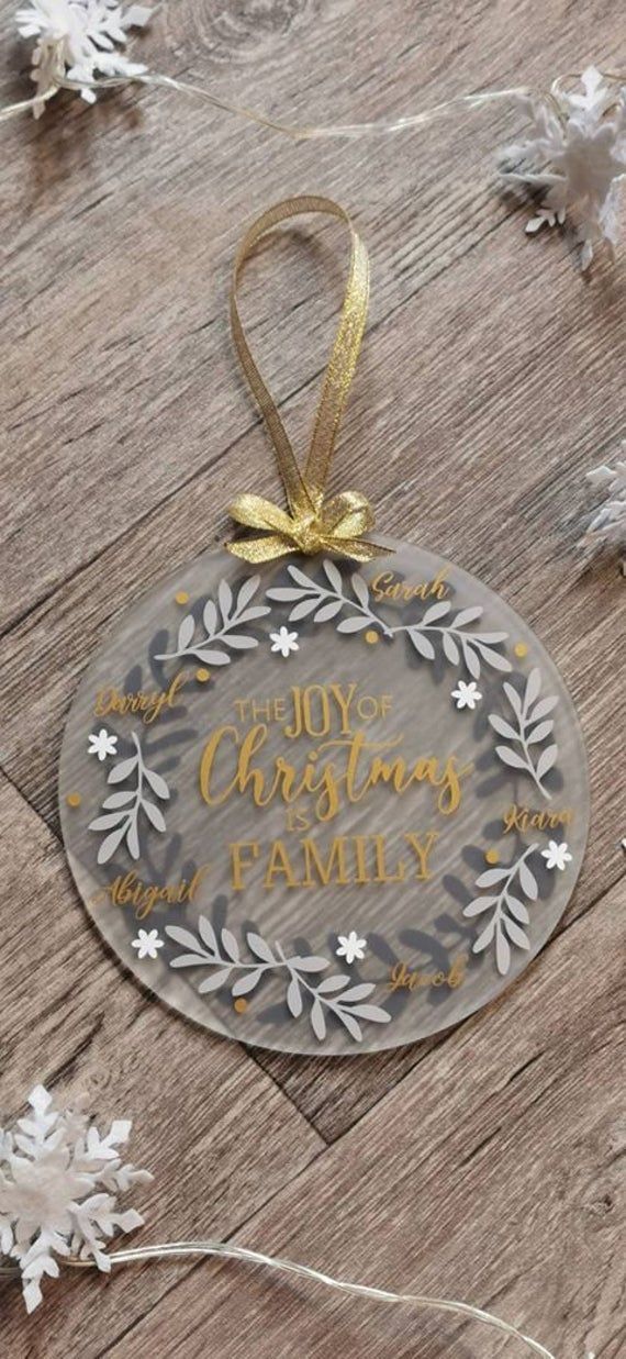 a glass ornament with the words joy christmas family on it