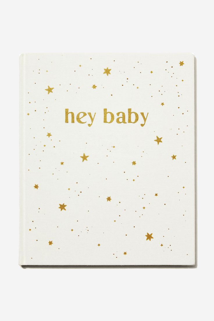 a white notebook with gold stars on the cover that says hey baby in gold lettering