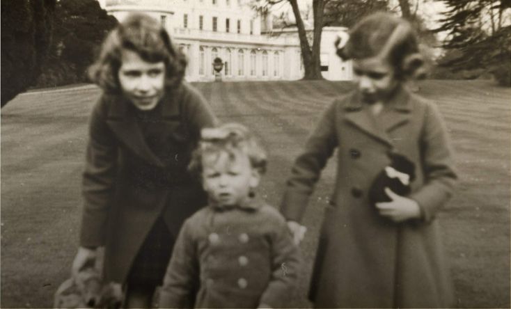 an old black and white photo of three children