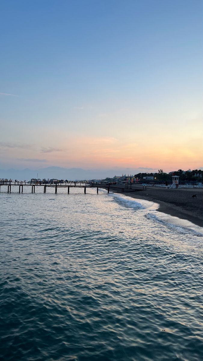 the water is calm and blue at sunset