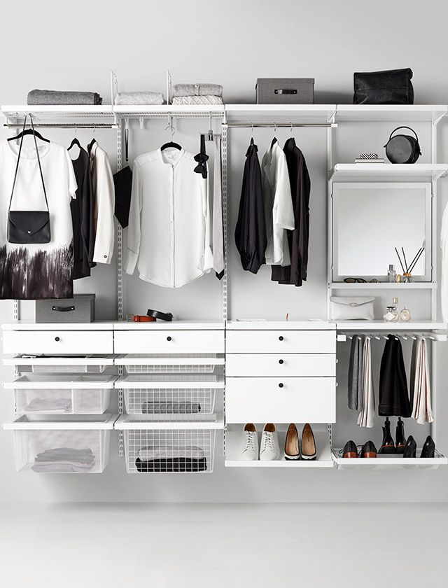 a white closet filled with lots of clothes