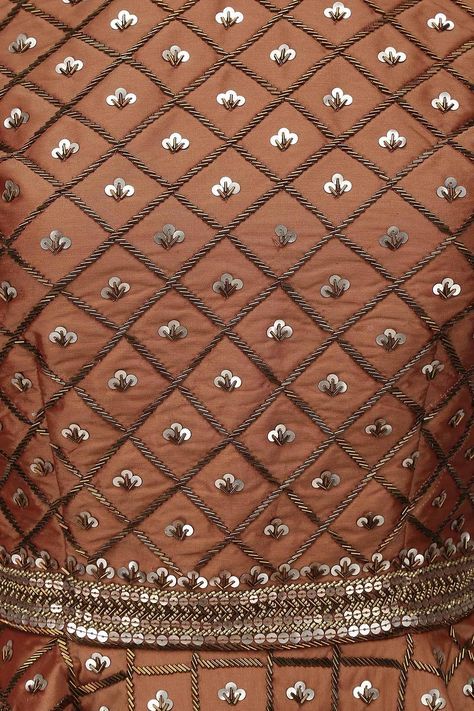 a brown dress with silver sequins on it