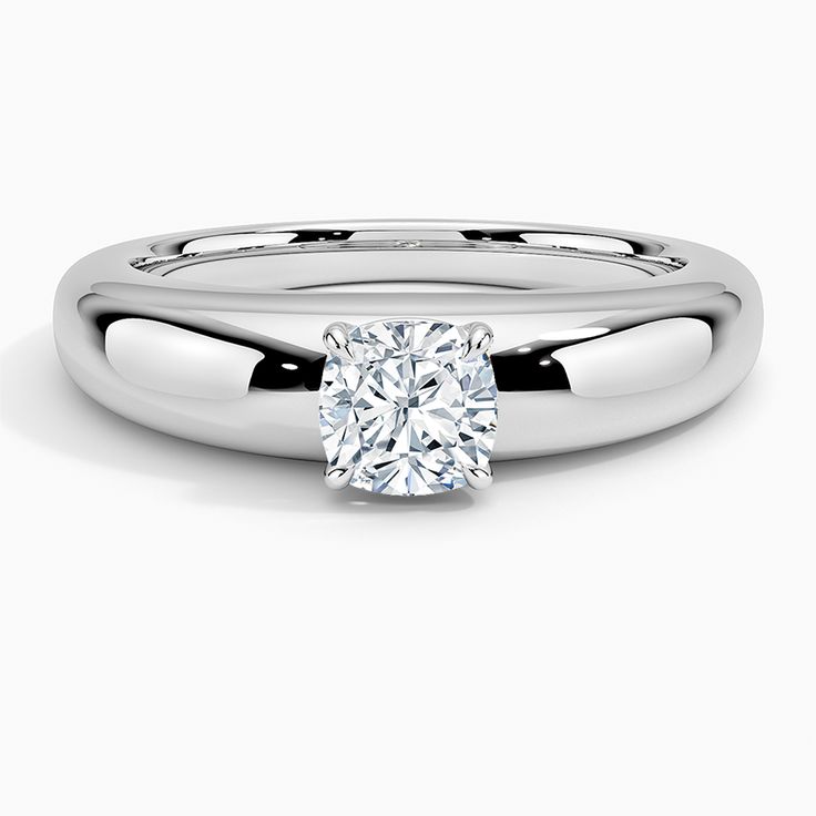 a white gold ring with a cushion cut diamond