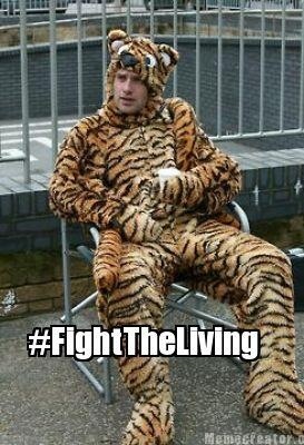 a man dressed as a tiger sitting in a chair