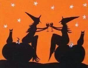 the silhouettes of two witches toasting wine glasses in front of an orange background