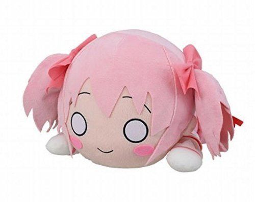 a pink stuffed animal with big eyes and hair on it's head is laying down