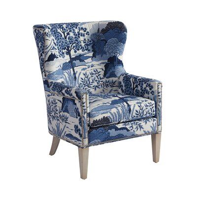 a blue and white chair with an upholstered arm