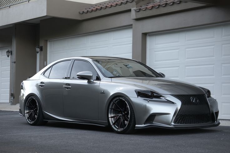 a silver car parked in front of a garage