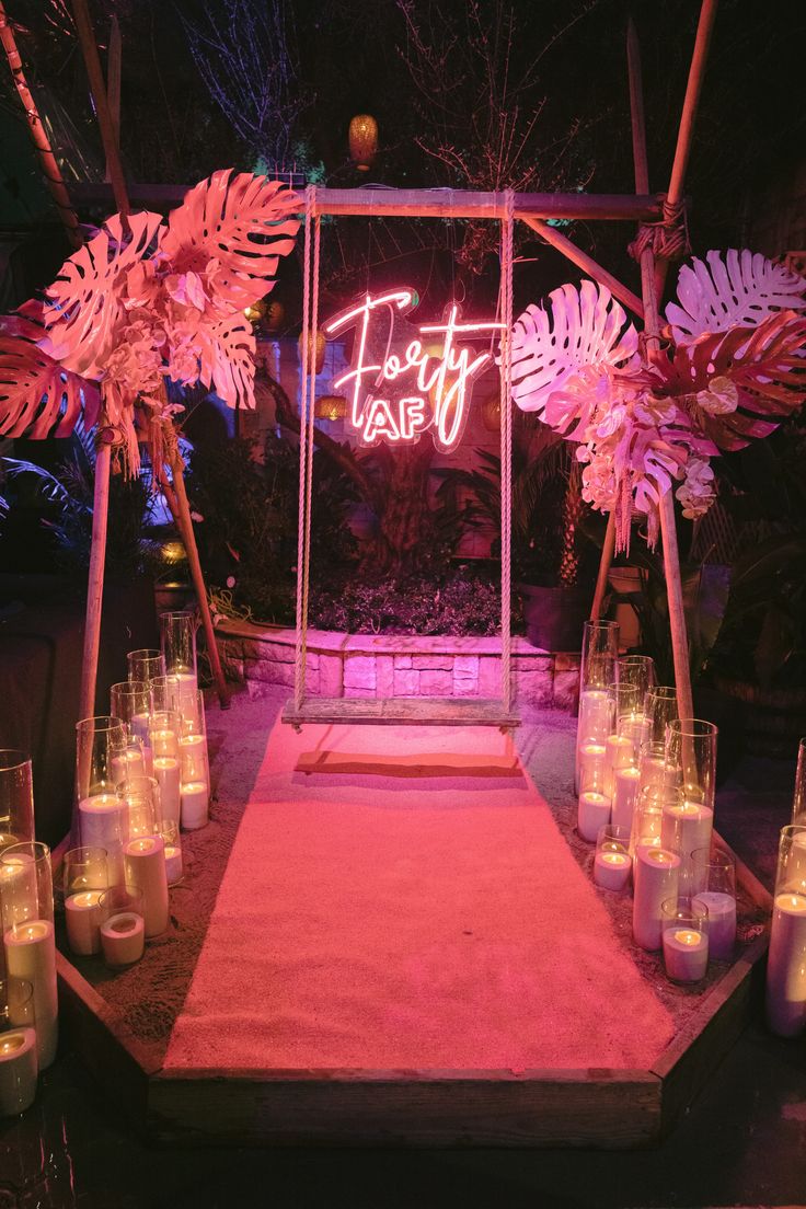 candles are lit in front of a neon sign that reads, toasty tapi