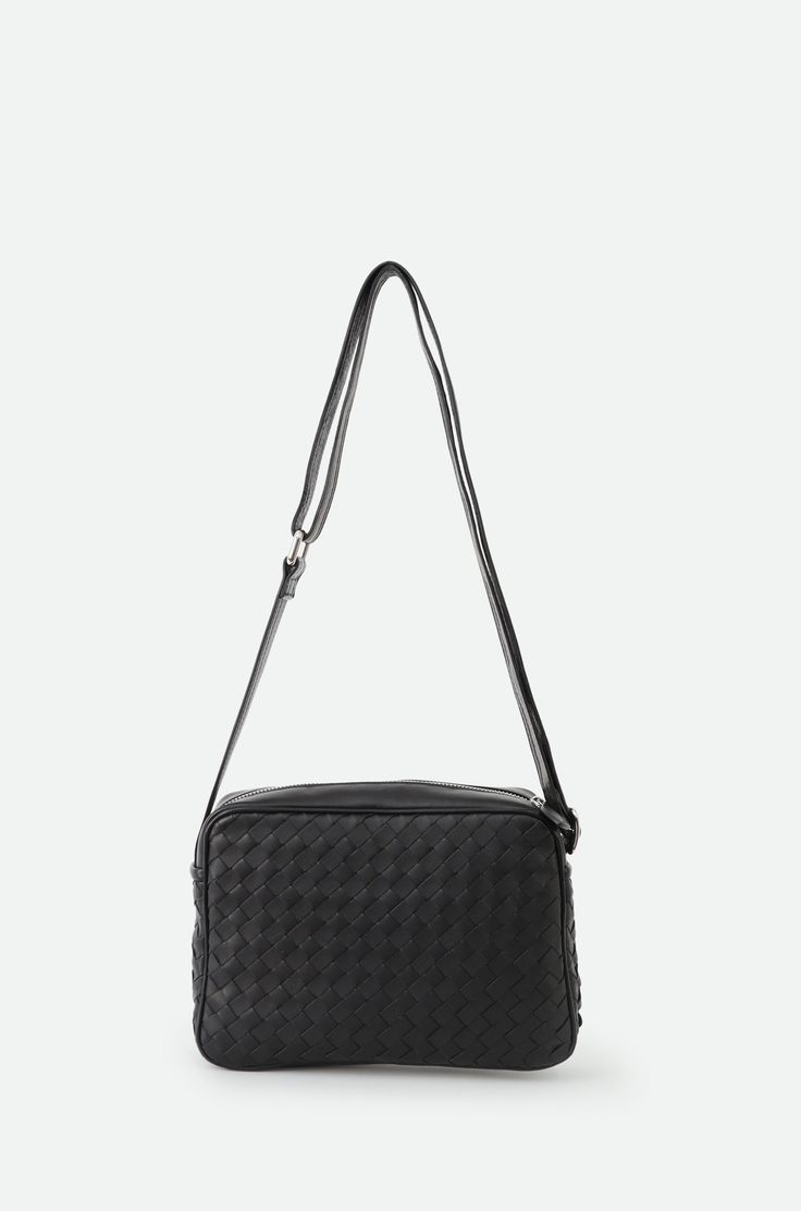 Presenting the Bari Bag—a statement of elegance and timeless charm. With its distinctive woven design and slim silhouette, this bag seamlessly complements any outfit, exuding a sense of relaxed sophistication. Meticulously handcrafted in Italy, using the finest lambskin leather, it epitomizes luxury and quality. Perfect for everyday wear and travel with a zippered closure, the Bari combines style with functionality, ensuring you stand out with every step. Details: Handmade in Italy Crafted from 100% smooth lambskin leather Designed by Segatta & Roth Complete inner lining Dimensions: 6 1/2" height, 9 1/2" width X 2 1/2" length Adjustable Strap length 34"-57" Includes an inner zippered pocket Product Code: ART.PI-106, BLACK Chic Woven Leather Business Bags, Elegant Woven Leather Travel Bag, Elegant Rectangular Woven Leather Bag, Elegant Woven Leather Shoulder Bag For Business, Business Intrecciato Weave Crossbody Bag, Elegant Rectangular Woven Leather Satchel, Classic Satchel Bags With Intrecciato Weave, Modern Formal Woven Leather Shoulder Bag, Classic Intrecciato Weave Satchel Bag