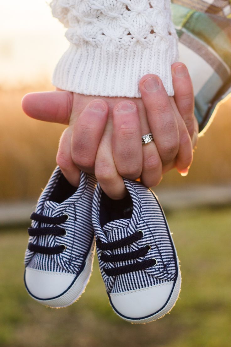 a person holding two pairs of shoes in their hands with the caption interest