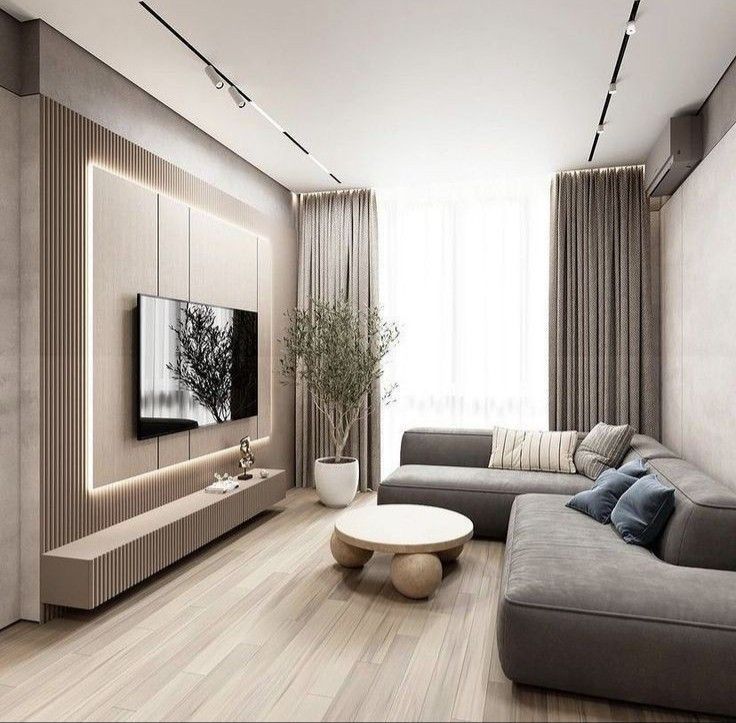 a living room with couches, tables and a television on the wall in it