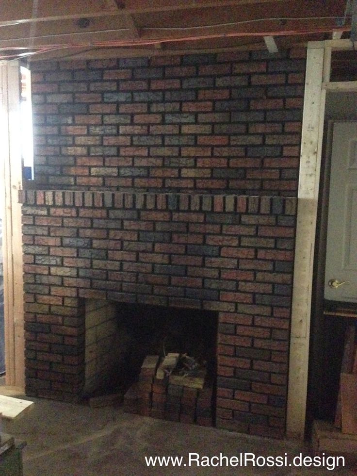 a brick fireplace in the middle of a room under construction