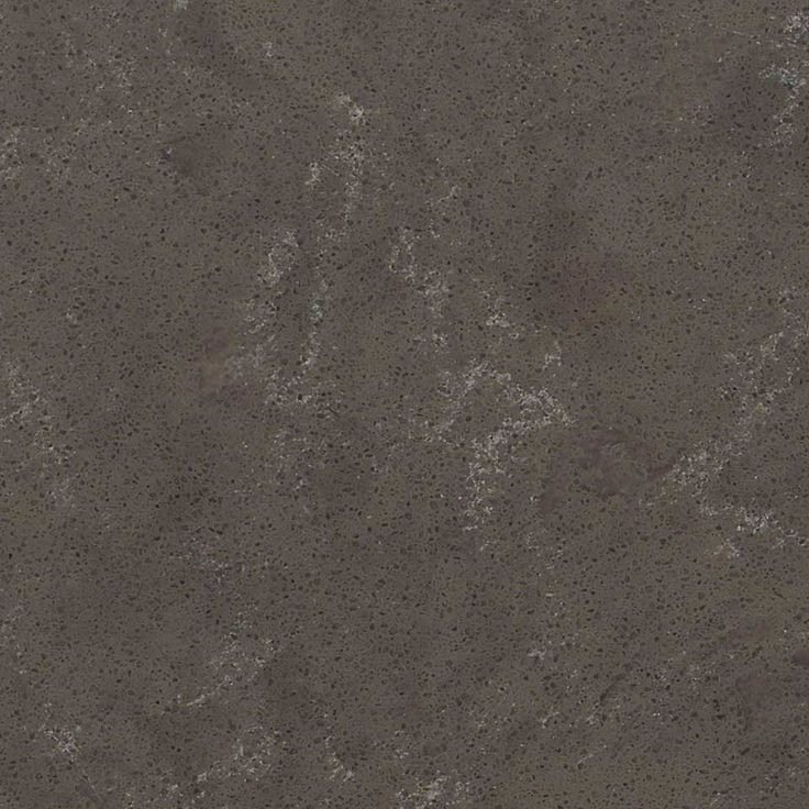 a close up view of the surface of a granite slab with dark brown and light gray colors