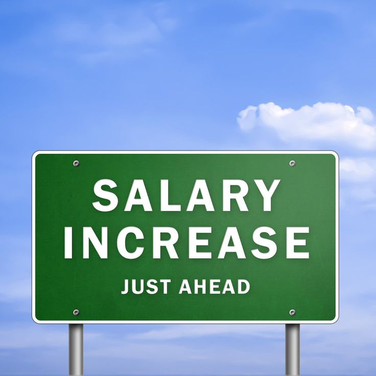 a green highway sign that says,'salary increase just ahead'against a blue sky with clouds