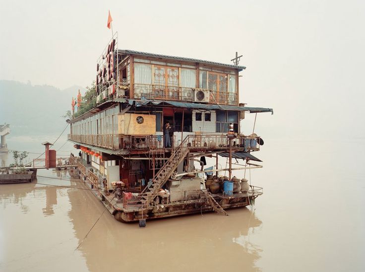 a house boat floating on top of a body of water