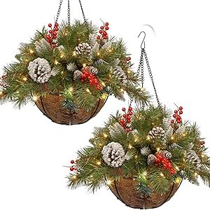 two baskets filled with pine cones and evergreen needles hanging from chains, decorated with christmas lights