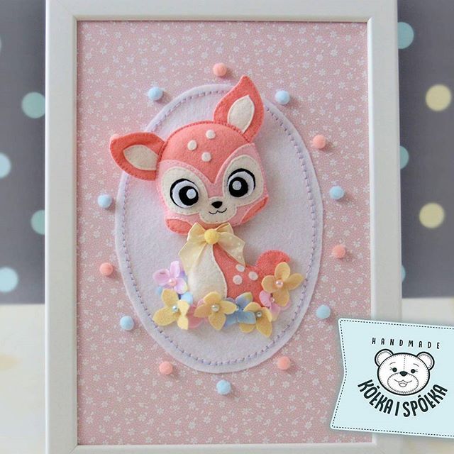 a pink and white frame with a stuffed animal in it