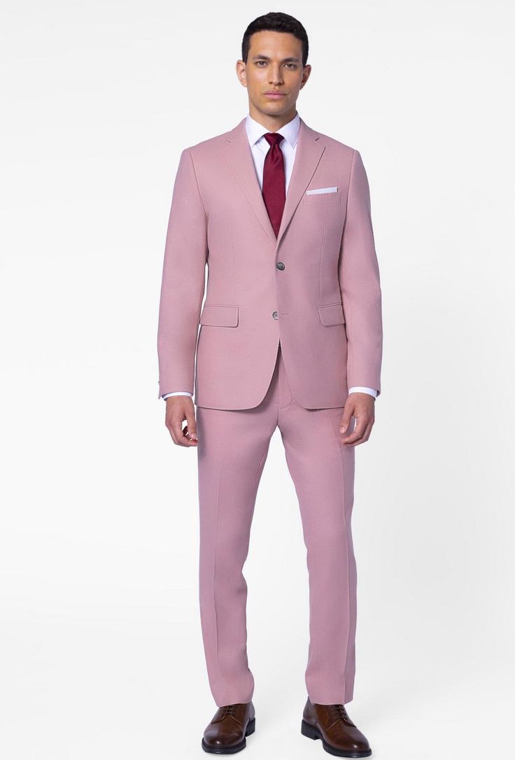 a man wearing a pink suit and tie