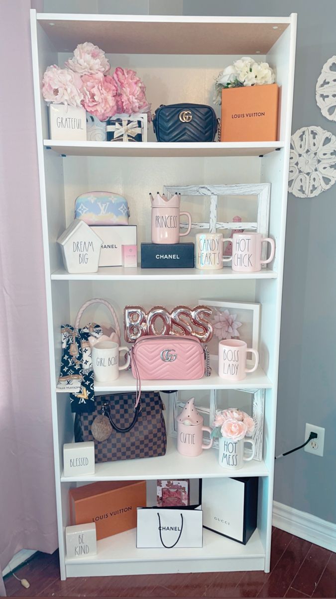 a white shelf filled with purses and other items