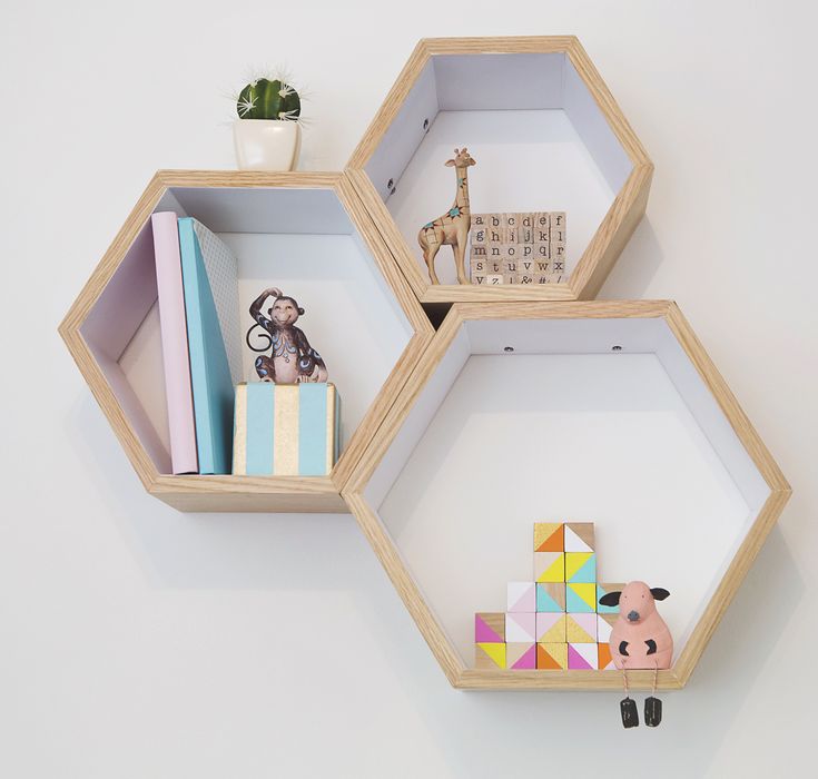 three hexagonal shelves with toys and books on them in the shape of hexagons