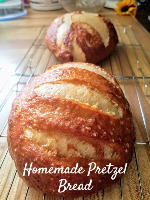 two loaves of bread sitting on top of a cooling rack with the words homemade pretzel bread