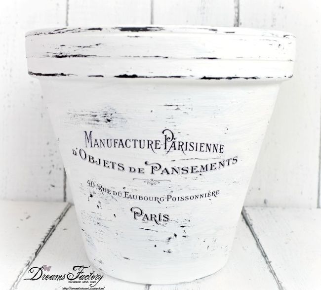 an old white bucket sitting on top of a wooden table with the words manufacture parsiene