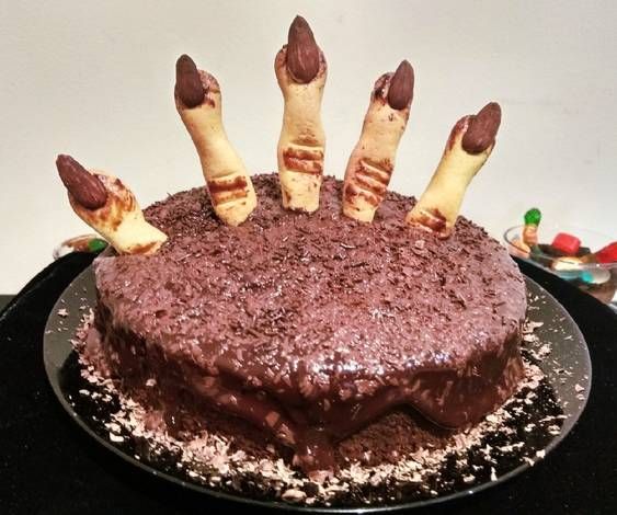 a cake with chocolate frosting and candy sticks sticking out of it's middle