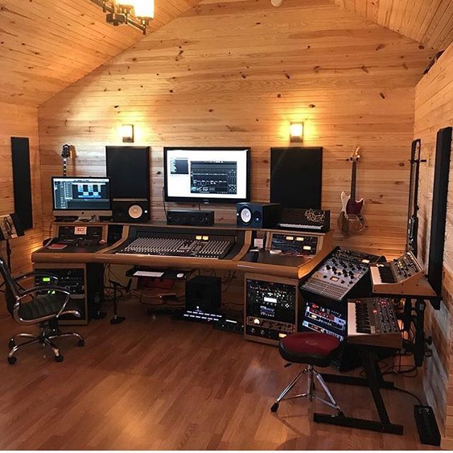 a recording studio with multiple monitors and sound equipment