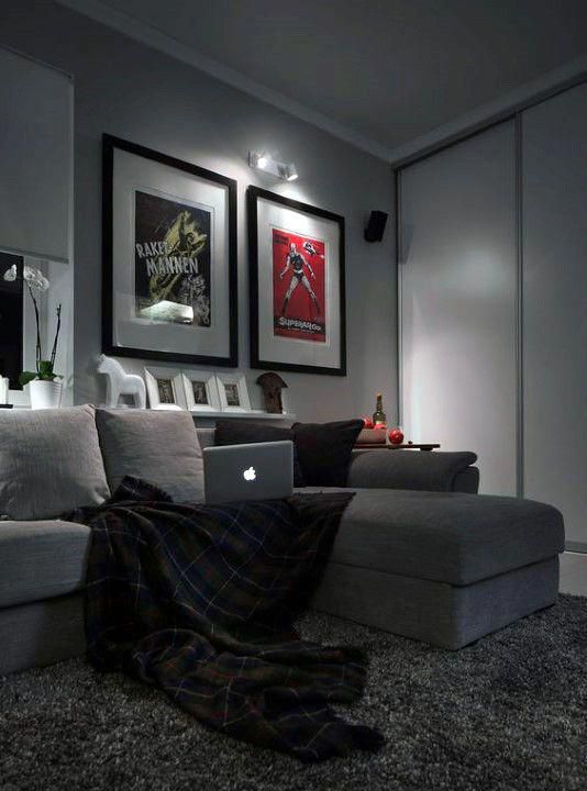 a living room with couches and pictures on the wall above them in black and white