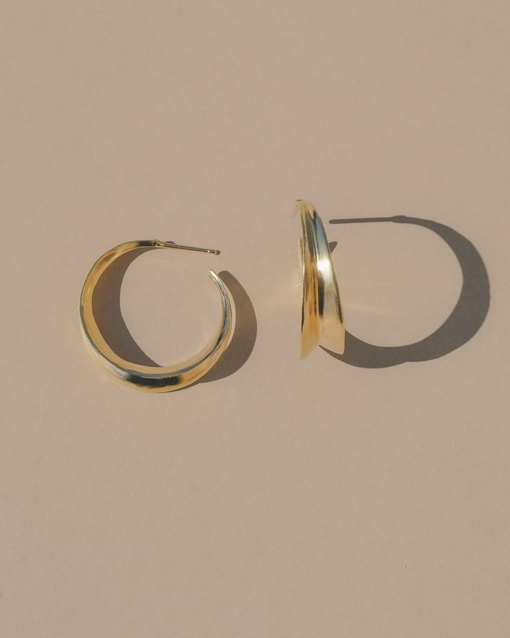 Carved minimal inverted light weight hoop stud earrings. A unique take on a classic style. Options: Sterling silver Gold Vermeil (14k gold over sterling silver)  Details: 27mm, 7.5 g Made with recycled metals Sold as a pair Made in the USA Minimalist 14k Gold Hoop Earrings With Shiny Finish, Minimalist Rounded Jewelry With Shiny Finish, Minimalist Gold-plated Earrings With Polished Finish, Minimalist Gold Plated Earrings With Polished Finish, Classic Hoop Earrings In Recycled Gold, Classic Small Hoop Earrings In Recycled Gold, Classic Gold Hoop Earrings In Recycled Gold, Classic Round Earrings In Recycled Gold, Modern Gold Hoop Earrings In Sterling Silver