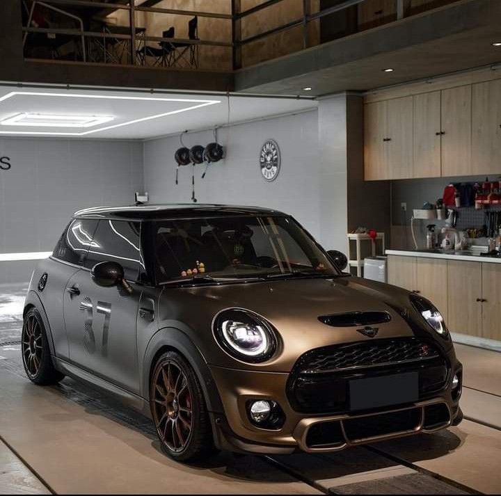 a small car parked in a garage next to a counter