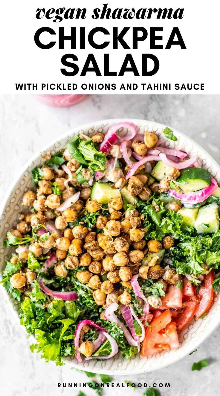 a white bowl filled with chickpea salad on top of a table