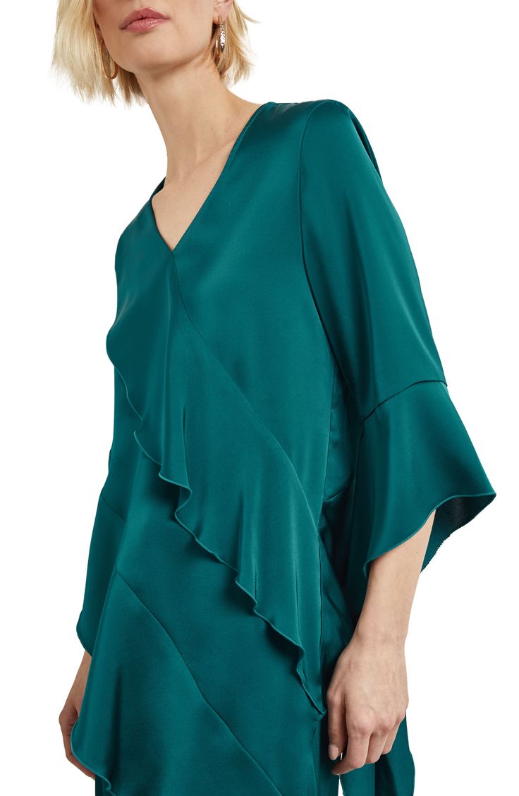 Asymmetric ruffles romance this V-neck top crafted from luxe satin and framed by cascading flutter sleeves. 12" length to 28" length V-neck Three-quarter sleeves 100% polyester Hand wash, dry flat Imported Draped Blouse With Ruffles, Elegant Ruffled V-neck Blouse, Elegant Asymmetrical Satin Top, Elegant V-neck Ruffle Blouse, Spring Satin Top With Asymmetrical Neckline, Silk Ruffled Evening Tops, Ruffled Top With Asymmetrical Neckline For Party, Asymmetrical Neckline Top With Ruffles For Party, Elegant Tops With Ruffles And Asymmetrical Neckline