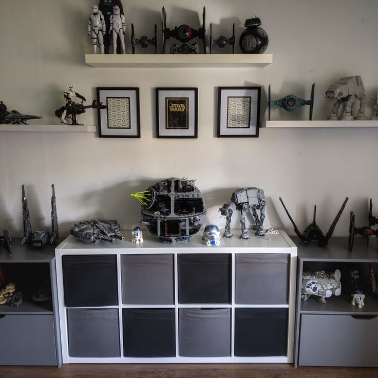 a room with shelves and pictures on the wall, including star wars figurines