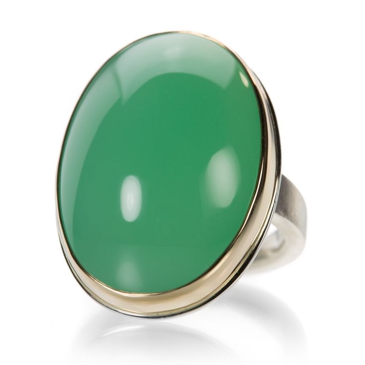 Deliciously delightful, this Jamie Joseph ring features a smooth oval chrysoprase cabochon. The sleek design is finished with a 14k yellow gold bezel and sterling silver X band. This ring is so lively that if you choose the occasion, it will be there! Stone measures about 7/8" x 1 1/8" including the bezel. Size 7.25. Handcrafted in Seattle, WA, U.S. Classic Green Oval Opal Ring, Classic Oval Chrysoprase Ring, Classic Green Opal Cabochon Ring, Classic Green Ring With Smooth Bezel, Green Oval Opal Ring With Polished Finish, Modern Green Oval Cabochon Jewelry, Elegant Green Opal Ring With Oval Cabochon, Elegant Green Opal Ring Oval Cabochon, Oval Green Onyx Rings