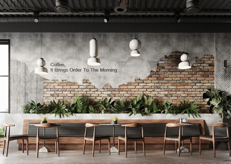 an industrial style restaurant with brick walls and plants on the wall, along with wooden tables and chairs