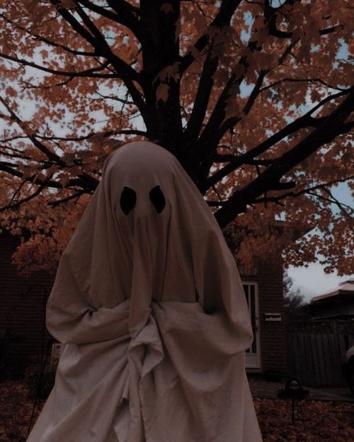 a ghostly ghost standing in front of a tree