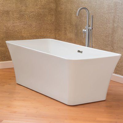 a white bath tub sitting on top of a wooden floor