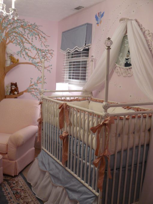 a baby's room decorated in pink and white with a canopy over the crib