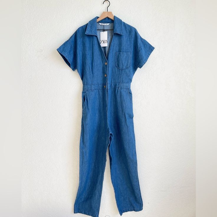 Jumpsuit With V-Neck Lapel Collar And Short Sleeves. Front Pockets And Back Patch Pockets. Straight Leg. Back Elastic Waistband. Front Button Closure. This Item Runs Small. The Length Is About 60 Inches. Denim Blue V-neck Jumpsuits And Rompers For Summer, Spring V-neck Denim Jumpsuit With Pockets, Summer Denim Blue V-neck Jumpsuit, Denim Blue V-neck Jumpsuit For Summer, Summer Workwear Denim Jumpsuit In Medium Wash, Summer Workwear Medium Wash Denim Jumpsuit, Summer Denim V-neck Jumpsuit With Pockets, Summer Denim Jumpsuit In Medium Wash For Work, Summer Medium Wash Denim Jumpsuit For Work