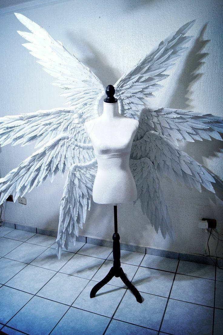 a mannequin with white wings on top of it