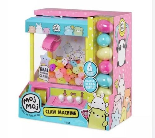 a small toy claw machine with lots of balls in it's display case on a white background